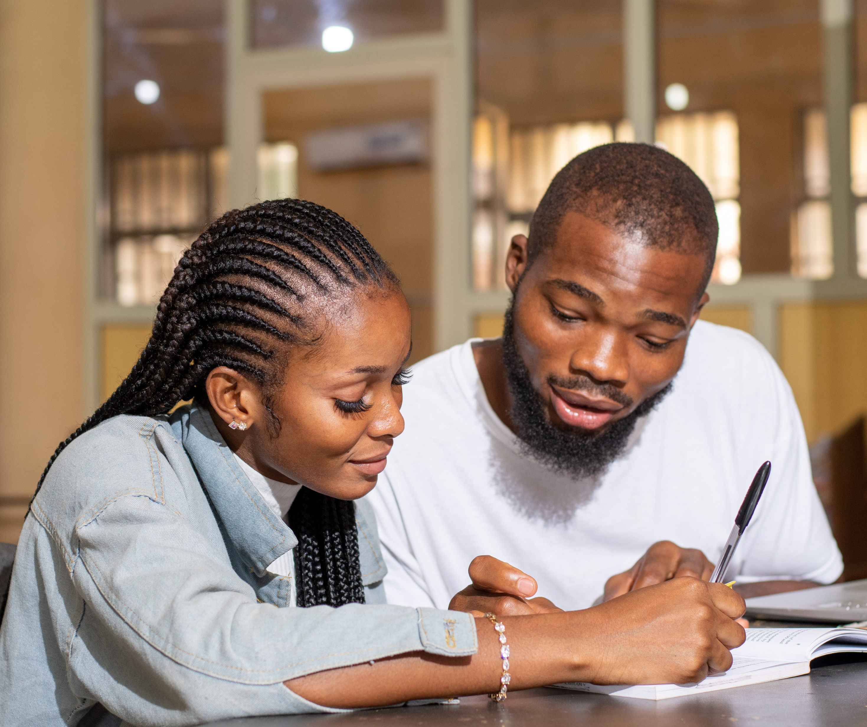 Two Bantwanas sitting at a table going over some documents.