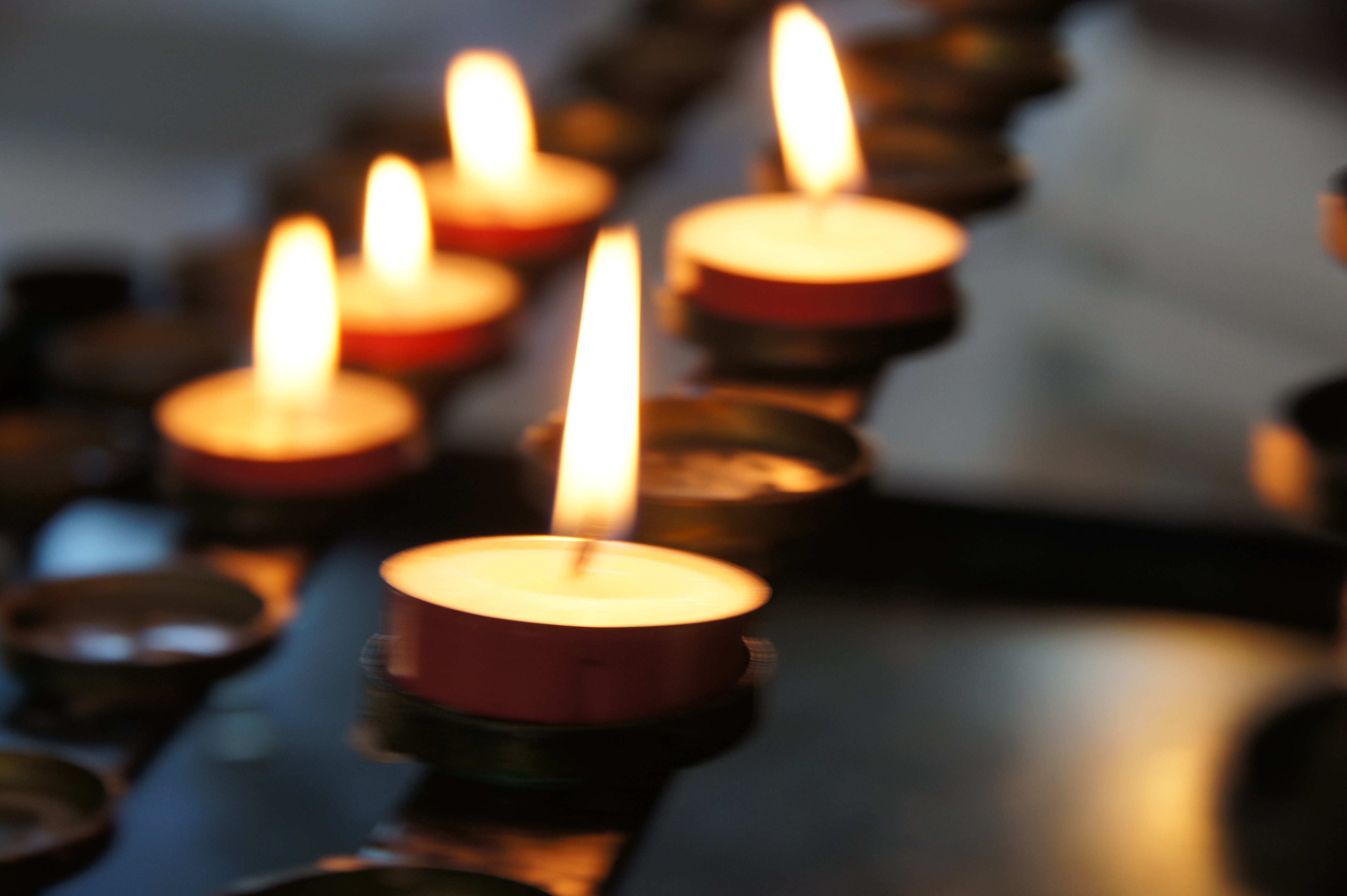 5 small candles lit in a close up shot