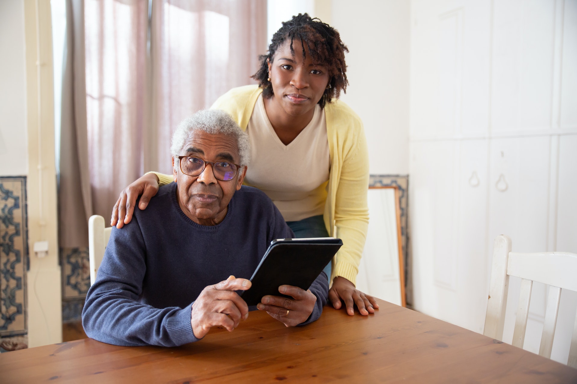 Pensioner with Caretaker on Tablet