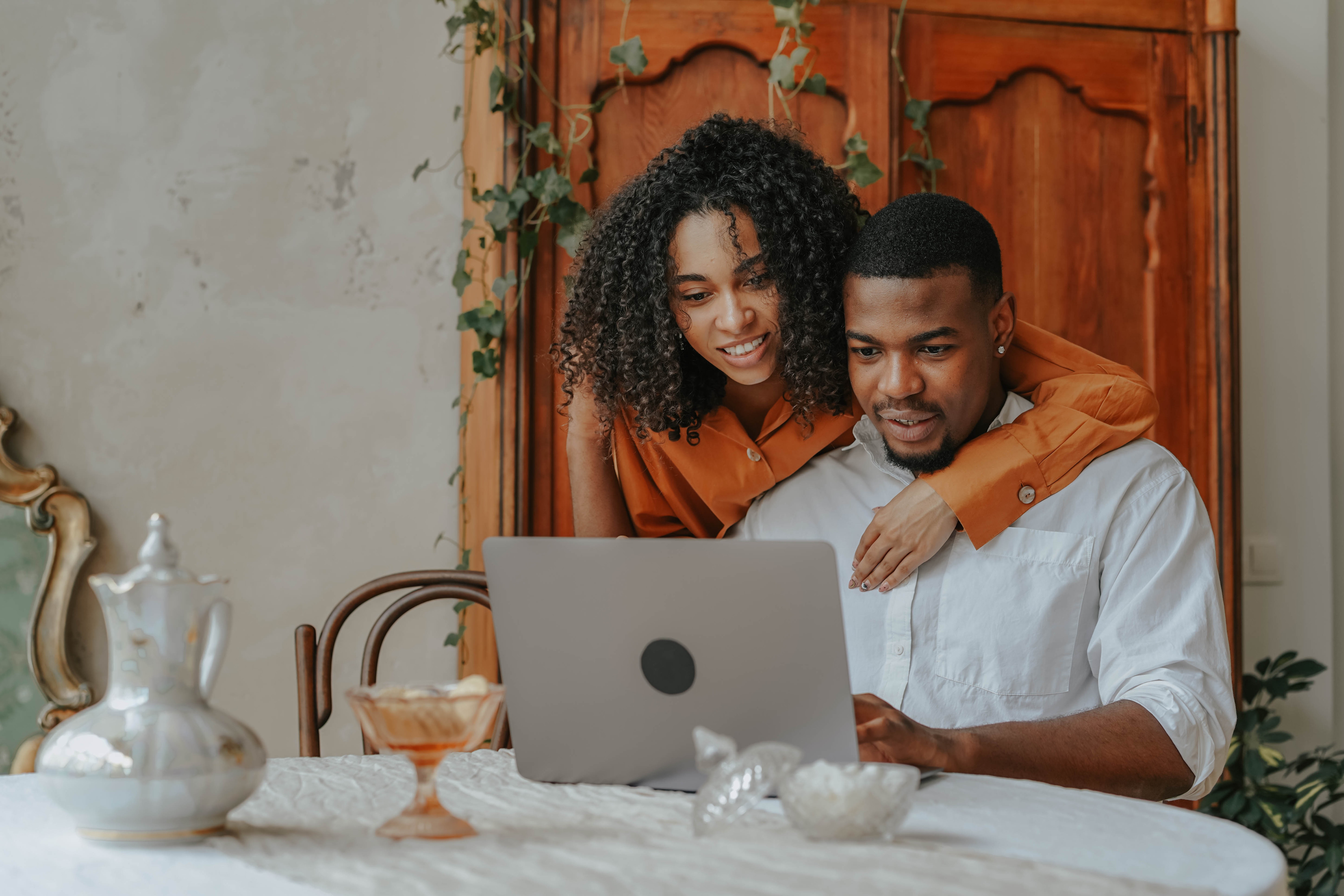 Couple looking at insurance company solutions together in their living room