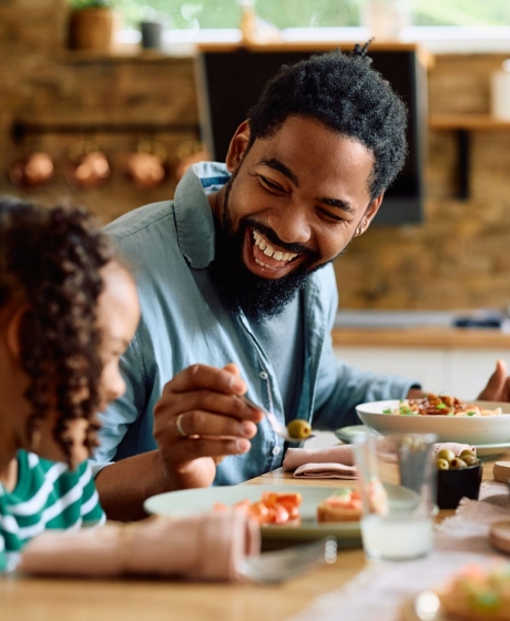 Father and daughter at breakfast table
