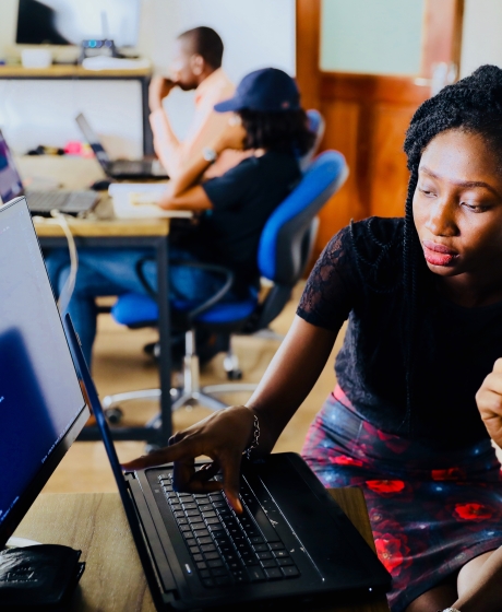 two web developers working at a desktop computer together