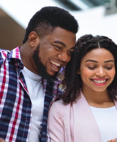 A young couple smiling in shopping mall