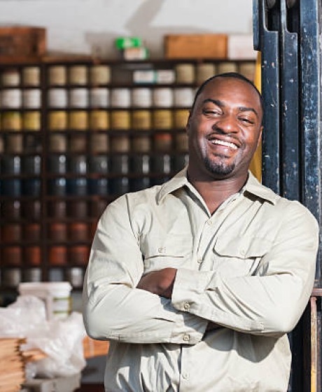 Business Man standing in front of his workshop