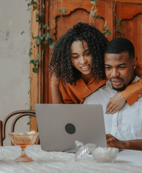 Couple looking at insurance company solutions together in their living room