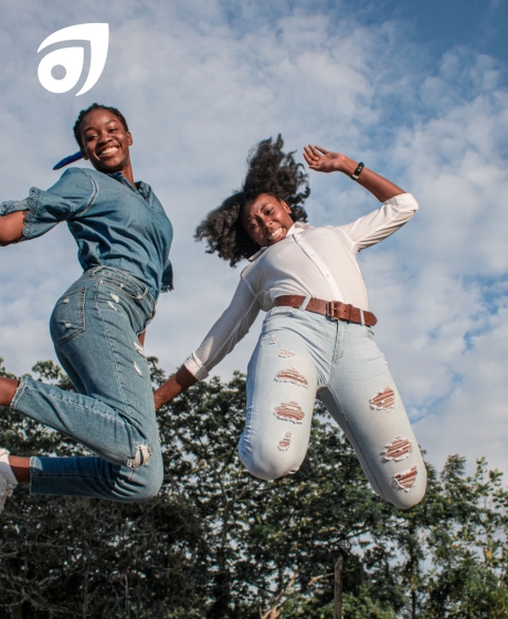 Two women jumping in the air