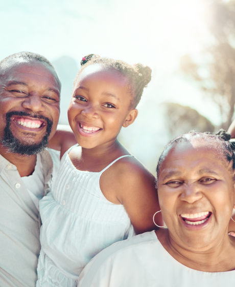 Family smiling outdoors