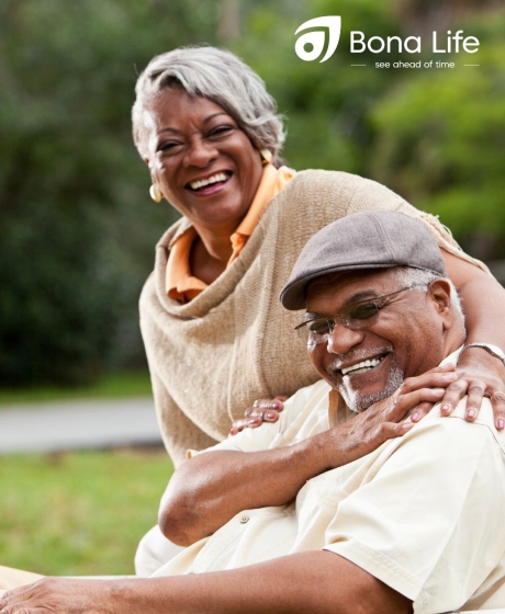 African couple outside on chair happy